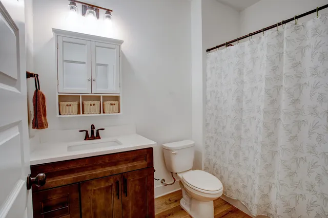 a bathroom with a sink a toilet and a mirror