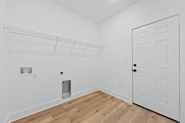 a view of a room with wooden floor