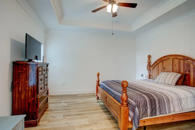 a bedroom with bed and wooden floor