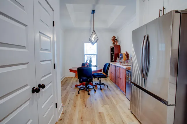 a view of a room with wooden floor and windows