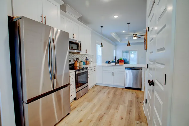 a kitchen with stainless steel appliances a refrigerator sink and microwave