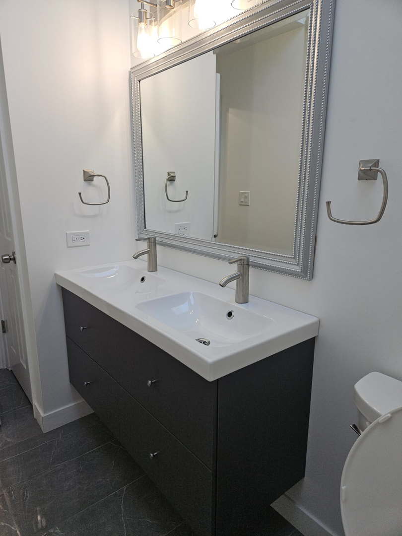 2011 Maplewood Circle Naperville, IL 60563 - Photo 21 of 43 a bathroom with a sink and mirror with toilet