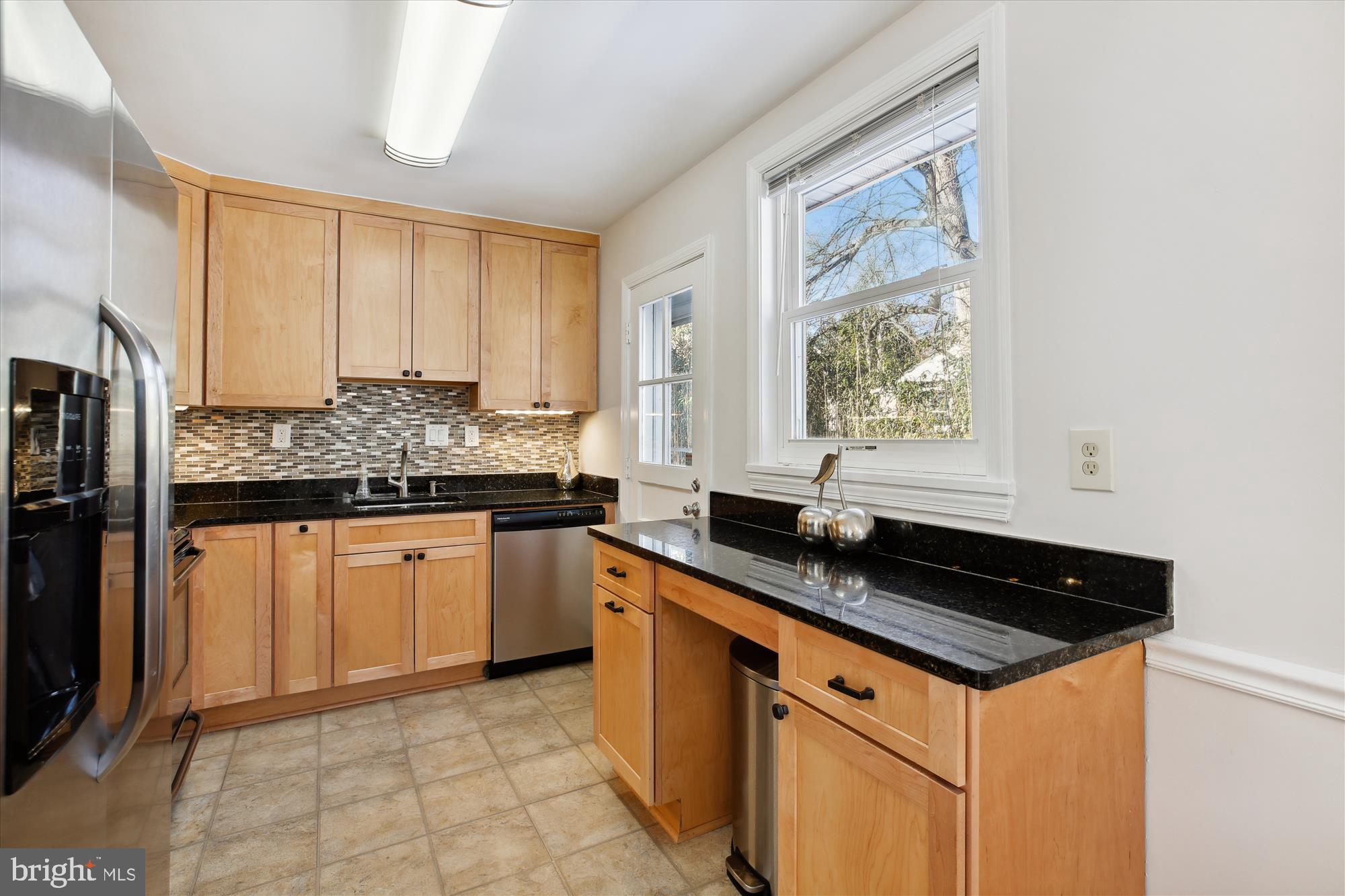 401 Greenbrier Drive Silver Spring, MD 20910 - Photo 17 of 57 a kitchen with stainless steel appliances granite countertop a sink stove and cabinets