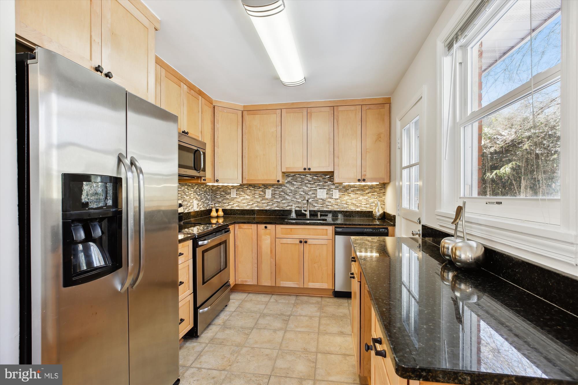 401 Greenbrier Drive Silver Spring, MD 20910 - Photo 18 of 57 a kitchen with stainless steel appliances granite countertop a stove a sink and a refrigerator