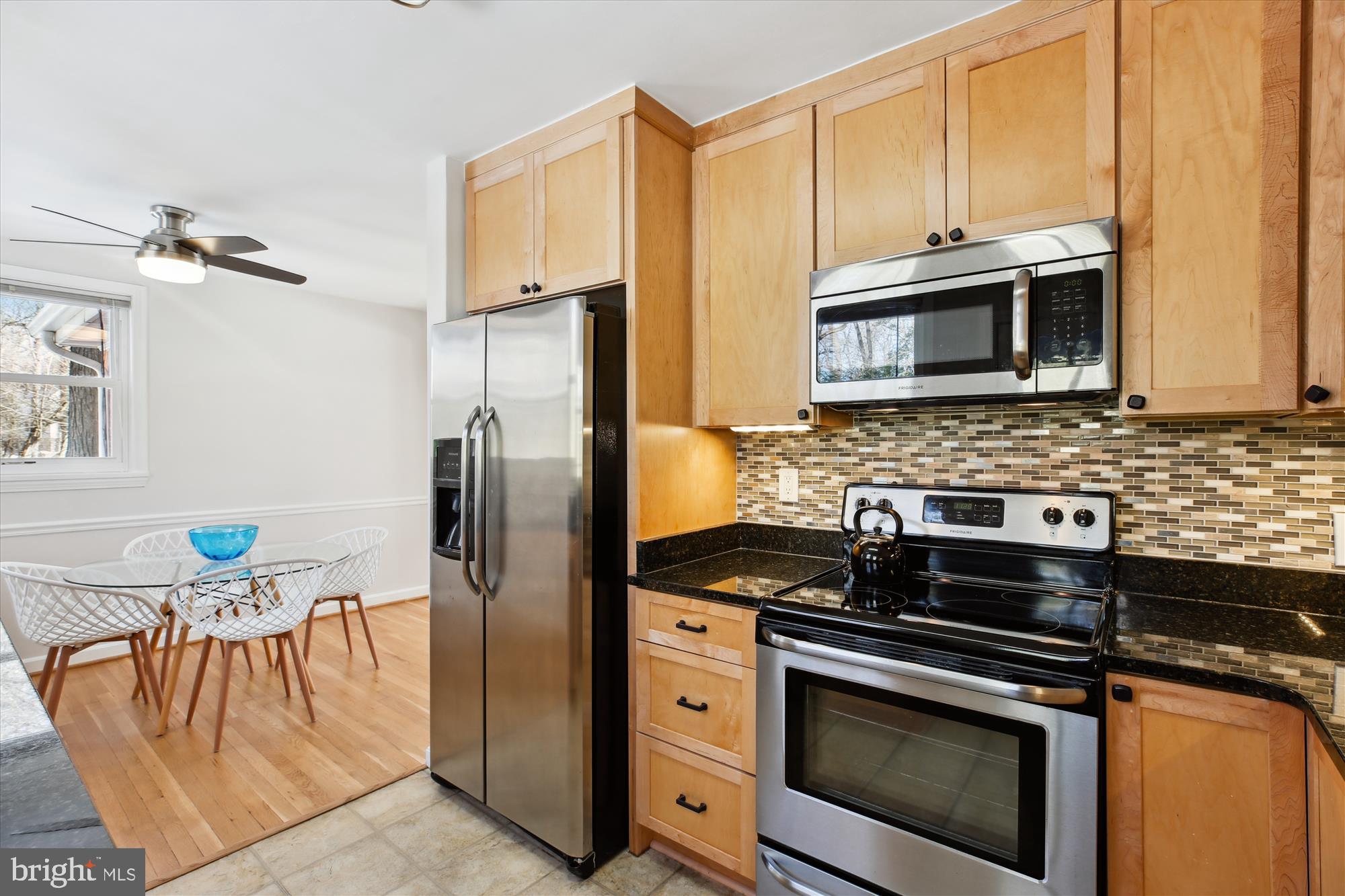 401 Greenbrier Drive Silver Spring, MD 20910 - Photo 19 of 57 a kitchen with stainless steel appliances granite countertop a stove microwave and refrigerator