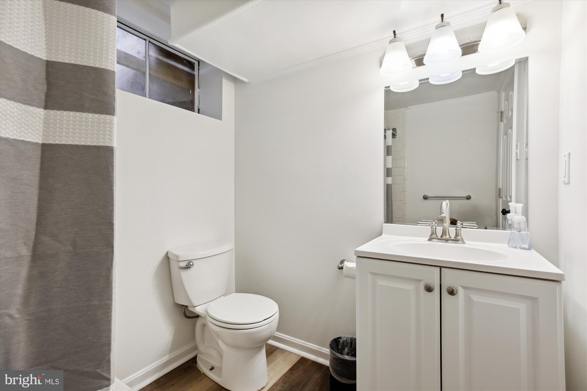 401 Greenbrier Drive Silver Spring, MD 20910 - Photo 40 of 57 a bathroom with a sink a toilet and mirror