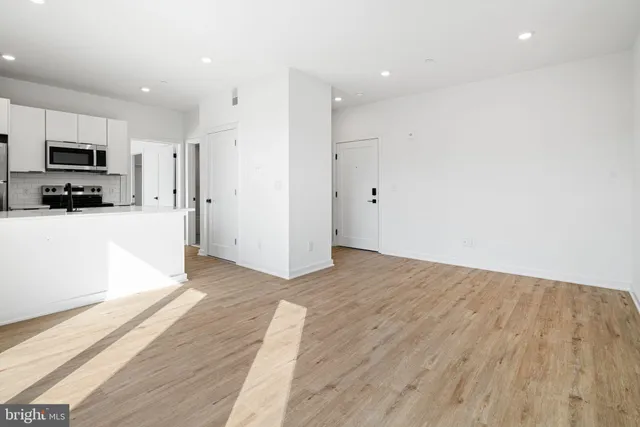 a view of a kitchen with wooden floor and a sink