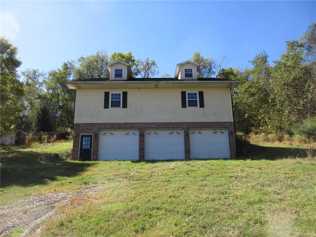 174 Adamson Road Marianna, PA 15345 - Photo 16 of 28 a front view of a house with garden