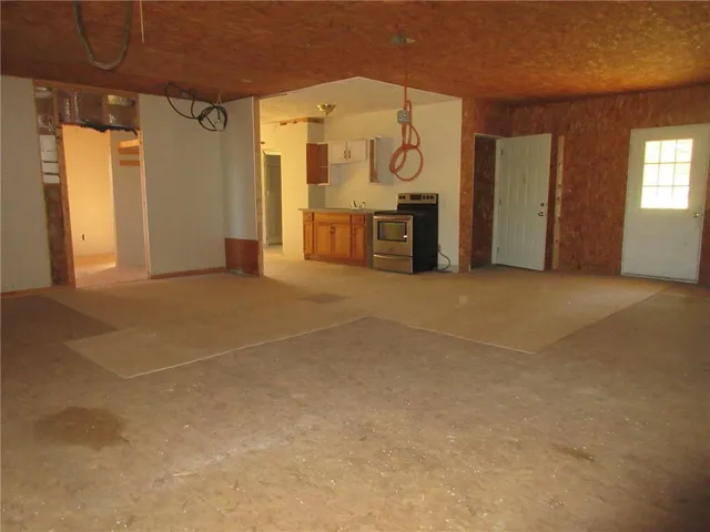 a kitchen with stainless steel appliances granite countertop a sink stove and cabinets