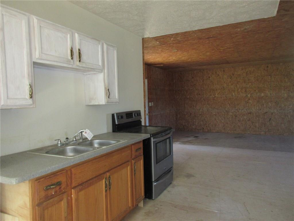 174 Adamson Road Marianna, PA 15345 - Photo 18 of 28 a kitchen with stainless steel appliances granite countertop a sink stove and cabinets