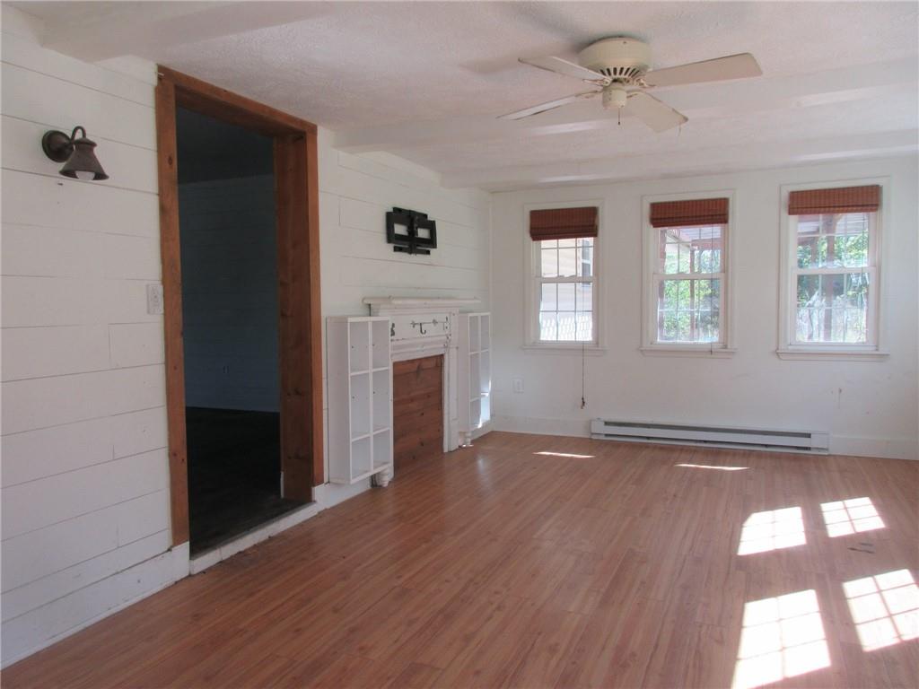 174 Adamson Road Marianna, PA 15345 - Photo 5 of 28 a view of an empty room with wooden floor and a window