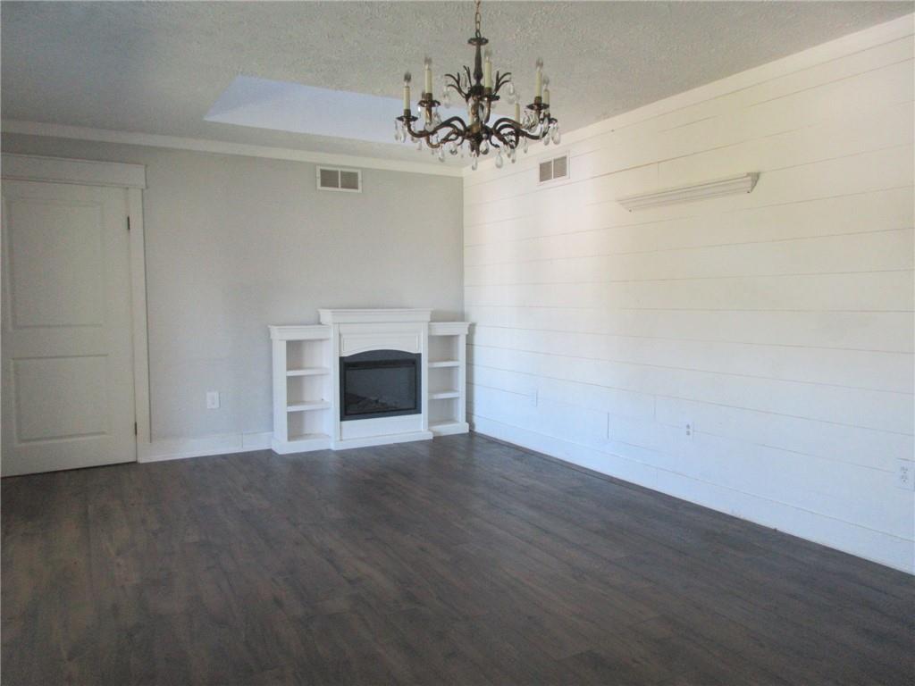 174 Adamson Road Marianna, PA 15345 - Photo 8 of 28 a view of an empty room with a fireplace and a chandelier fan