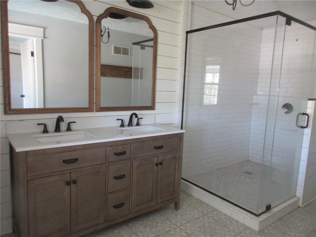 174 Adamson Road Marianna, PA 15345 - Photo 9 of 28 a bathroom with a double vanity sink mirror and shower