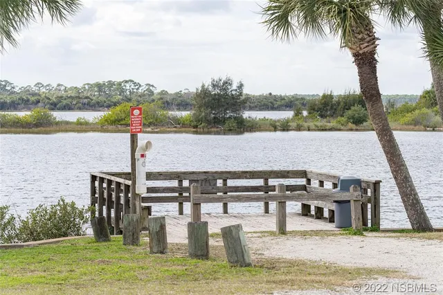 a view of swimming pool with a table and chairs