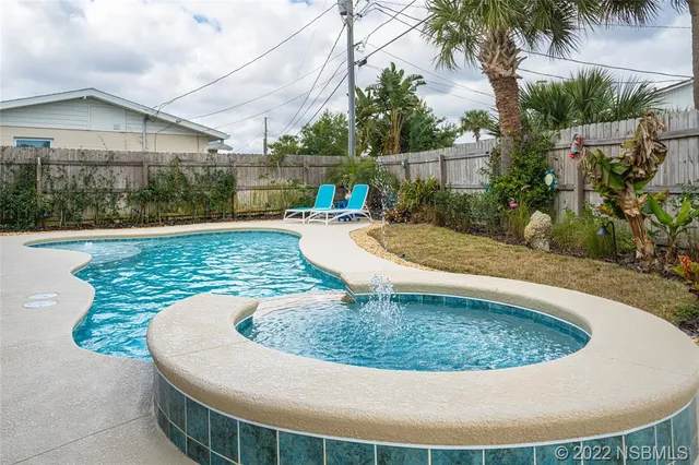 a view of a swimming pool with a patio
