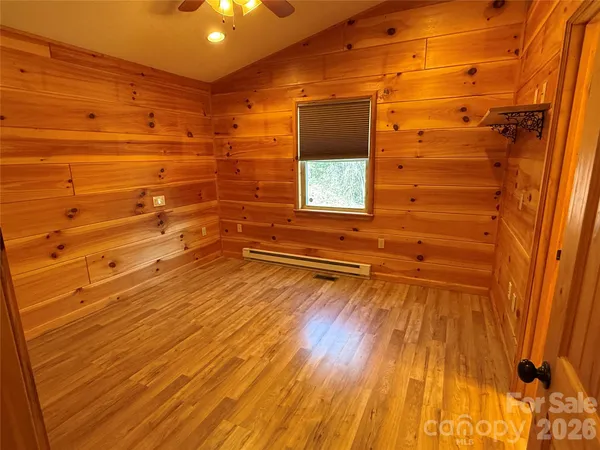 a view of a room with wooden floor