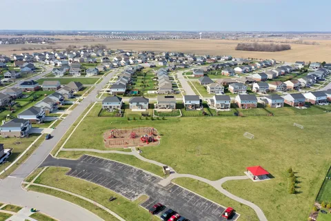 an aerial view of residential houses with outdoor space