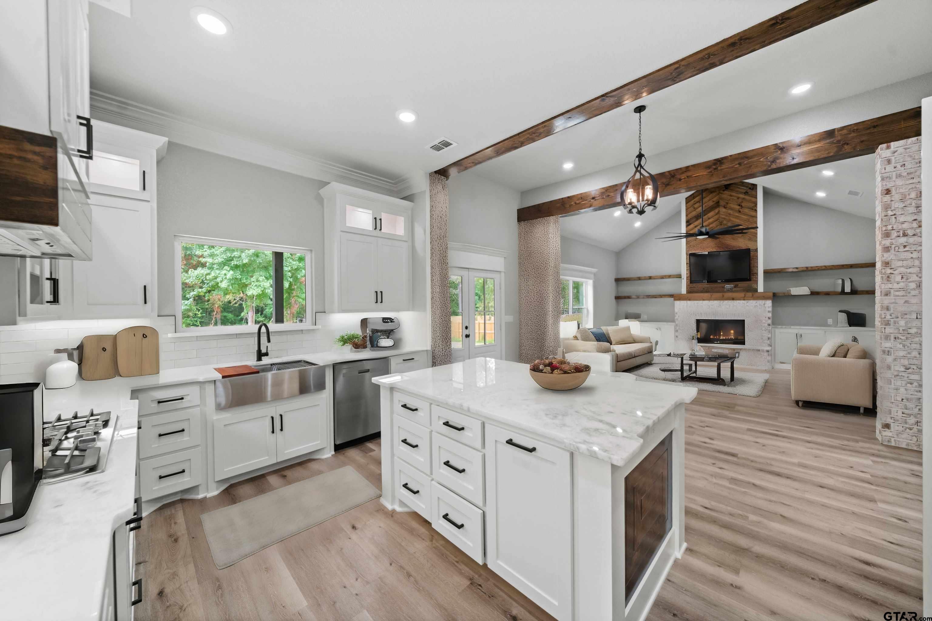 14552 Fallow Lane Tyler, TX 75706 - Photo 11 of 38 a kitchen with stainless steel appliances kitchen island granite countertop a sink dishwasher a stove and a refrigerator with wooden floor