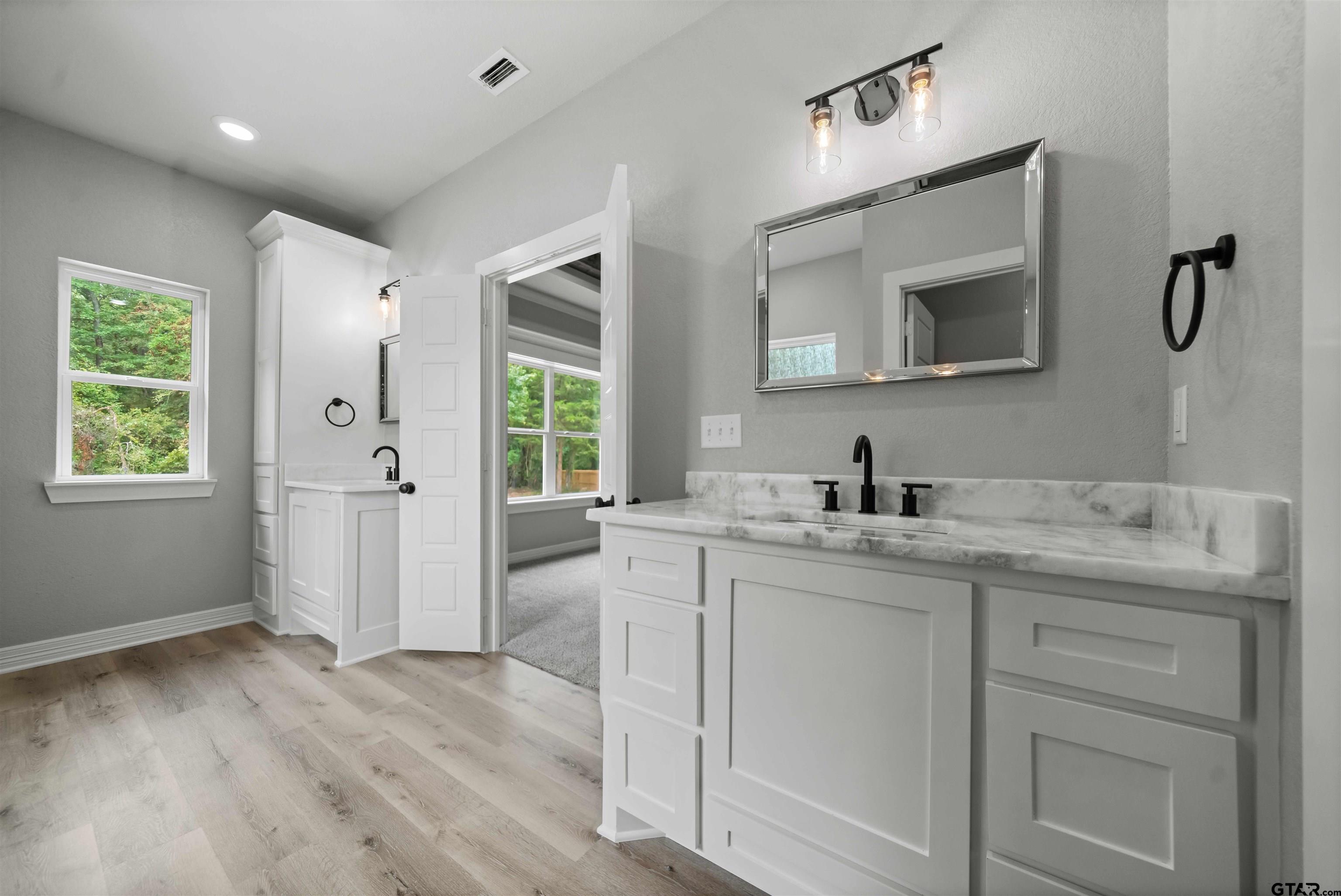 14552 Fallow Lane Tyler, TX 75706 - Photo 14 of 38 a bathroom with a granite countertop sink mirror and window