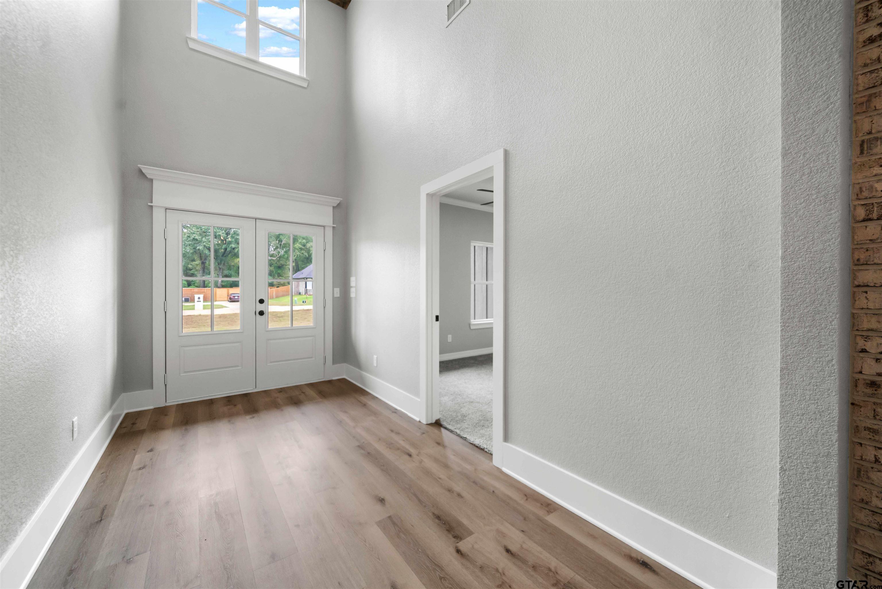 14552 Fallow Lane Tyler, TX 75706 - Photo 16 of 38 a view of a hallway with wooden floor and a living room