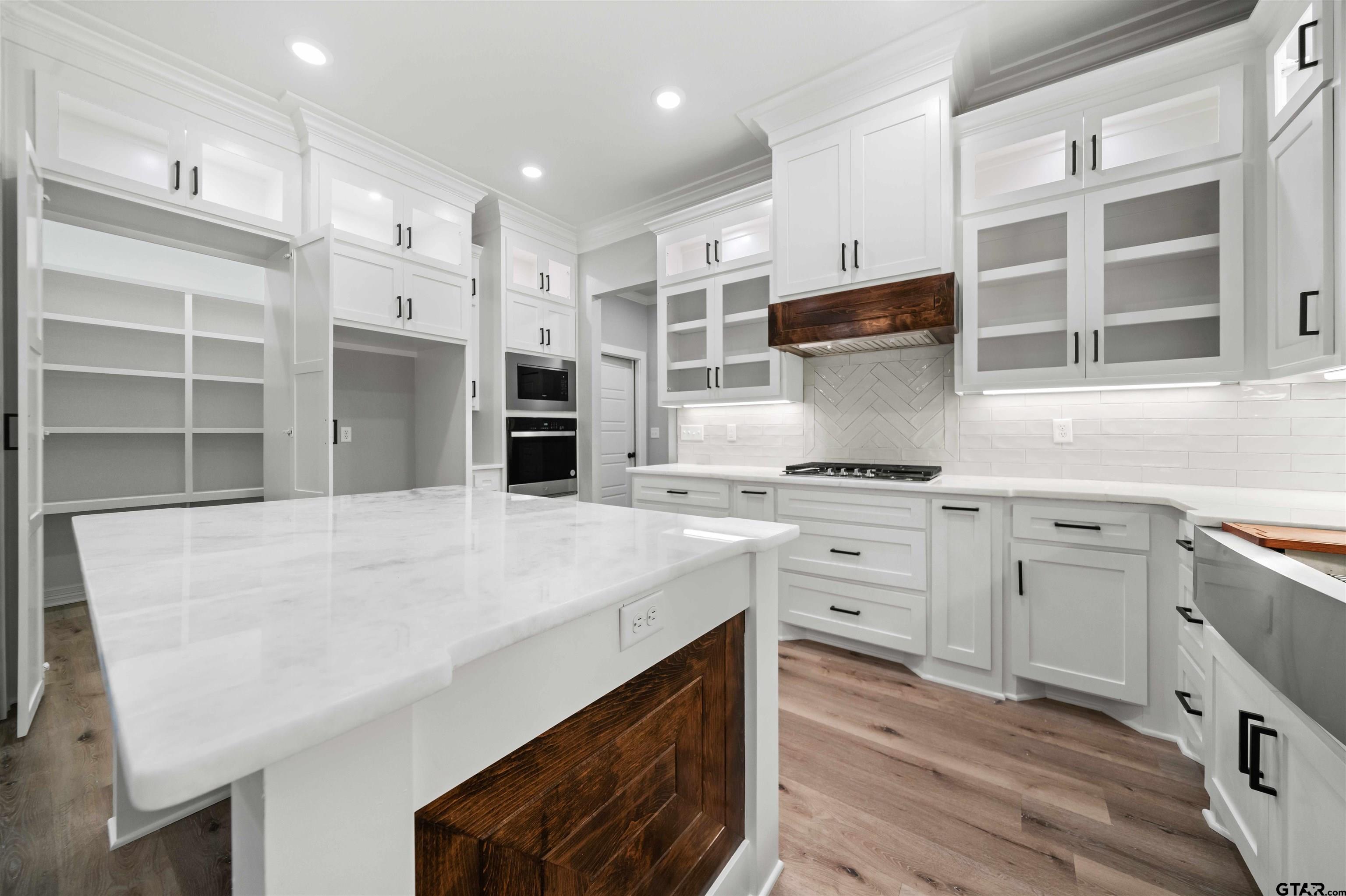 14552 Fallow Lane Tyler, TX 75706 - Photo 19 of 38 a kitchen with a sink dishwasher a stove and a refrigerator