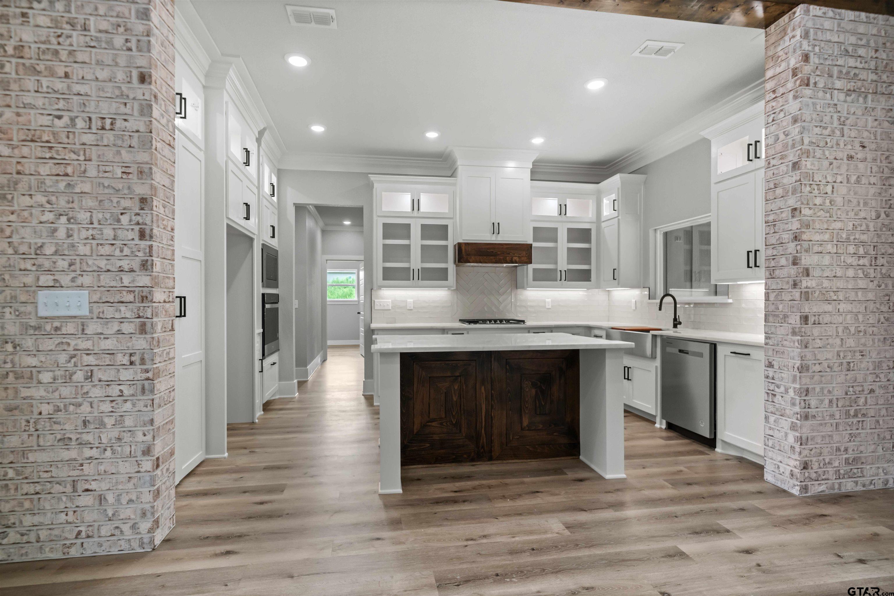 14552 Fallow Lane Tyler, TX 75706 - Photo 24 of 38 a kitchen with kitchen island granite countertop a sink cabinets and stainless steel appliances