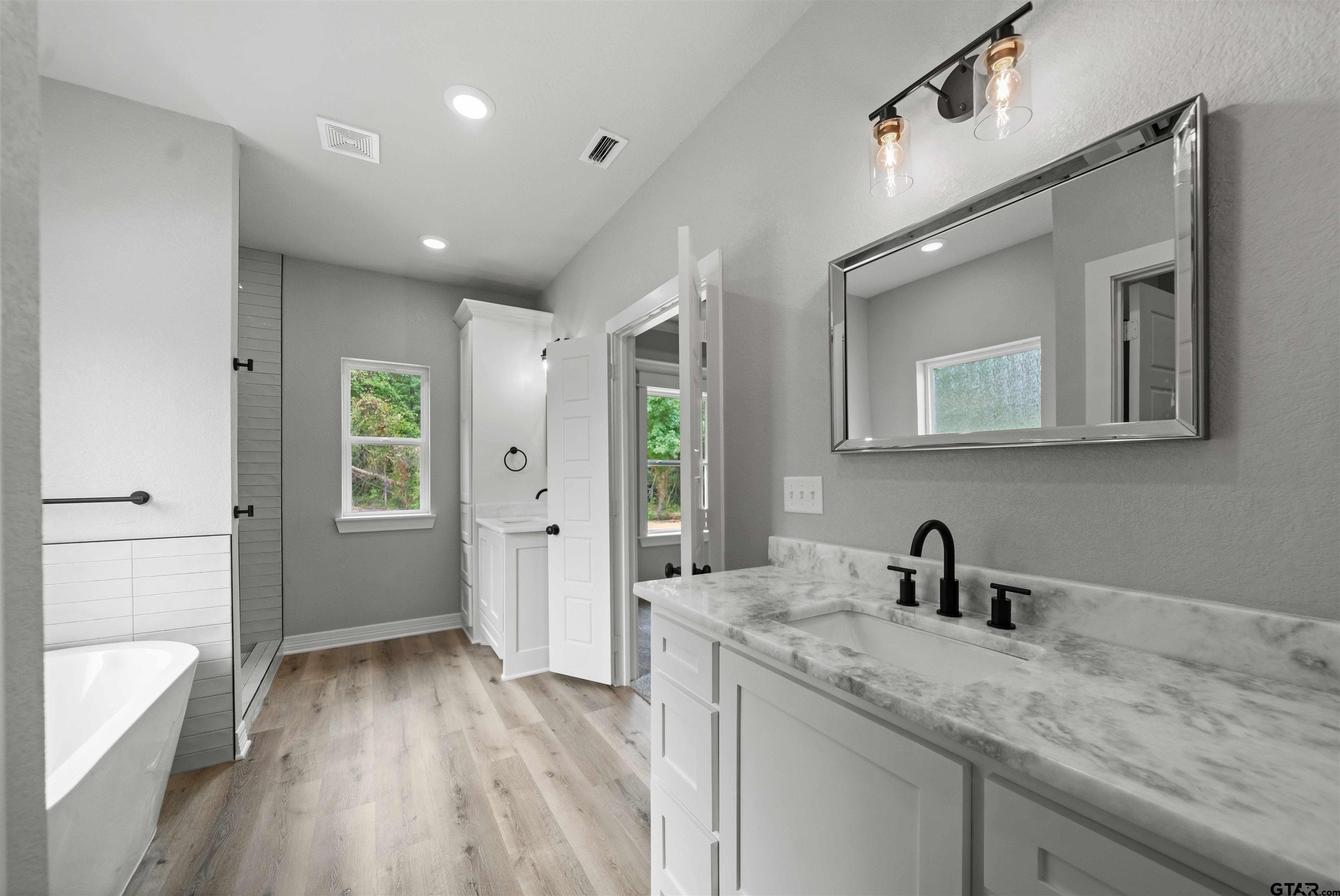 14552 Fallow Lane Tyler, TX 75706 - Photo 27 of 38 a kitchen with a sink and wooden floor