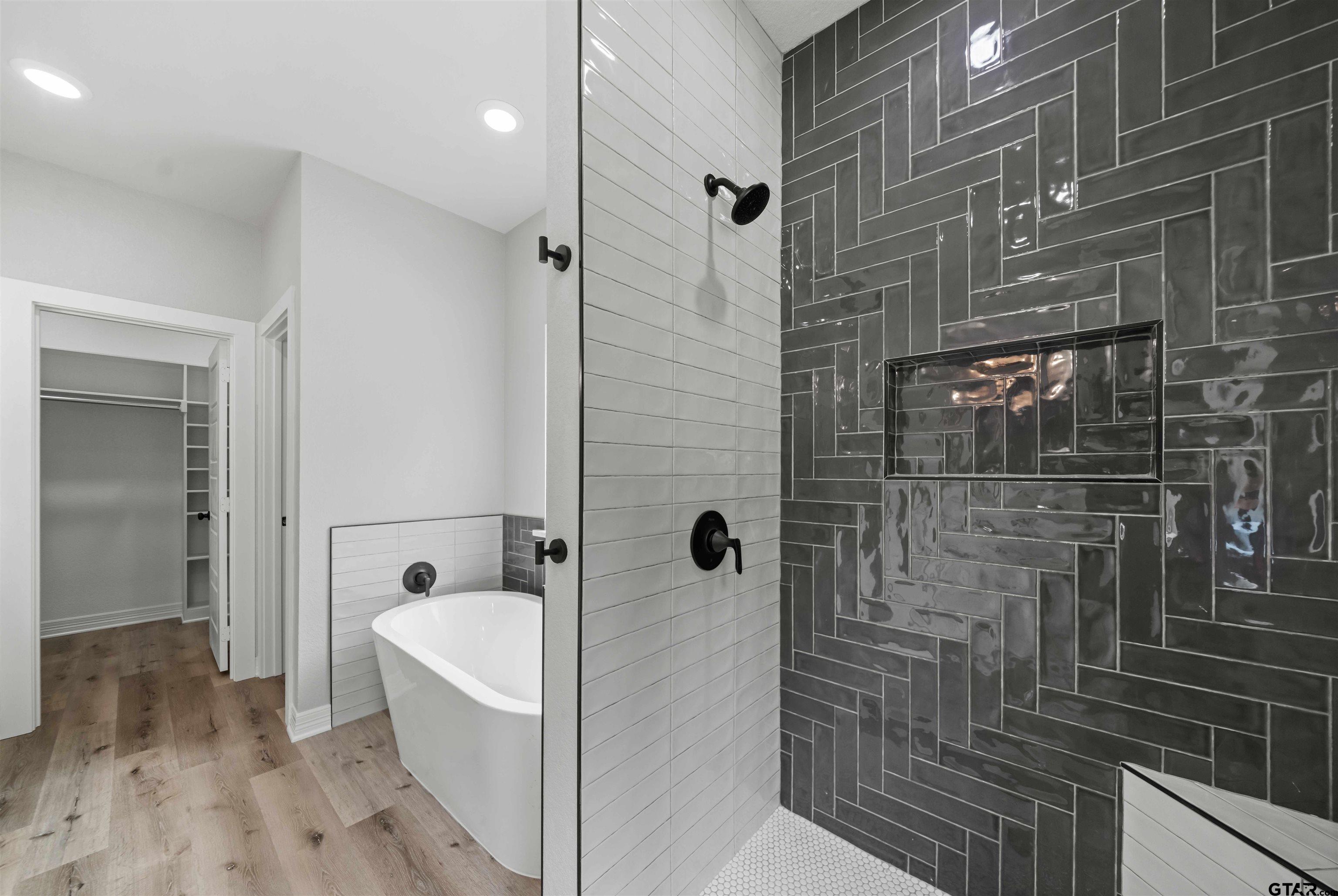 14552 Fallow Lane Tyler, TX 75706 - Photo 28 of 38 a bathroom with a bathtub and shower