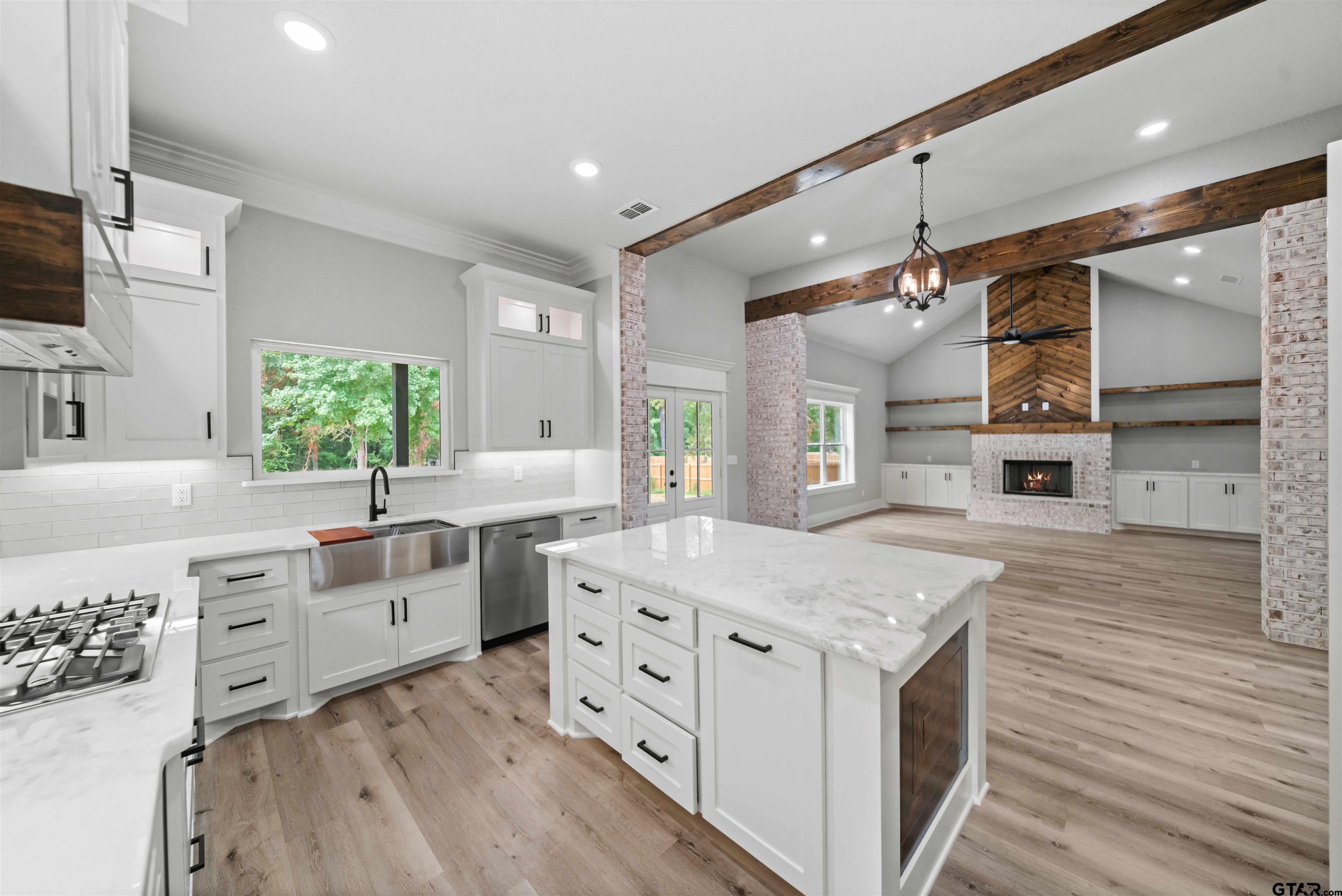 14552 Fallow Lane Tyler, TX 75706 - Photo 31 of 38 a kitchen with a stove cabinets and wooden floor