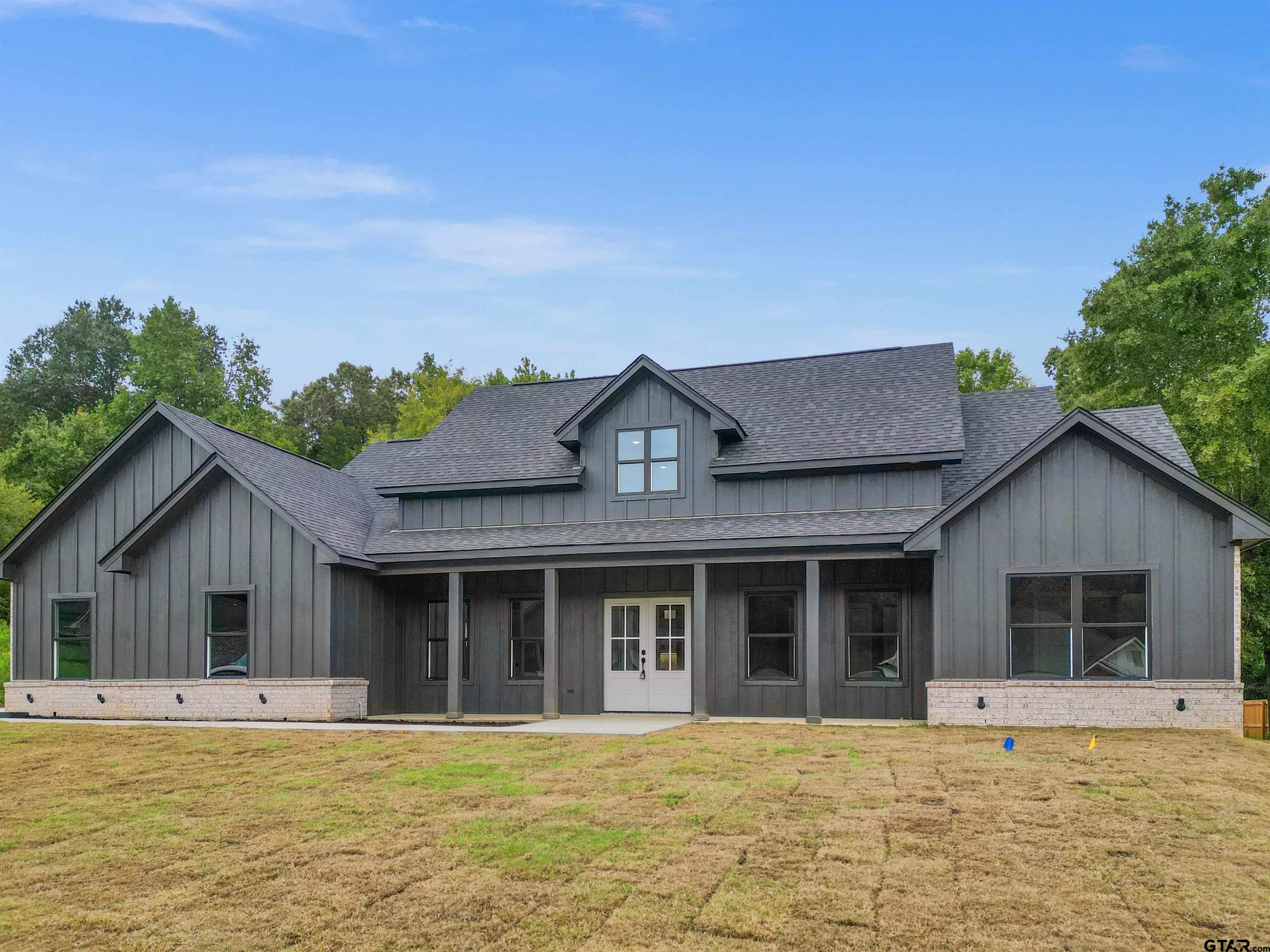 14552 Fallow Lane Tyler, TX 75706 - Photo 35 of 38 a view of a house with a swimming pool and a large tree