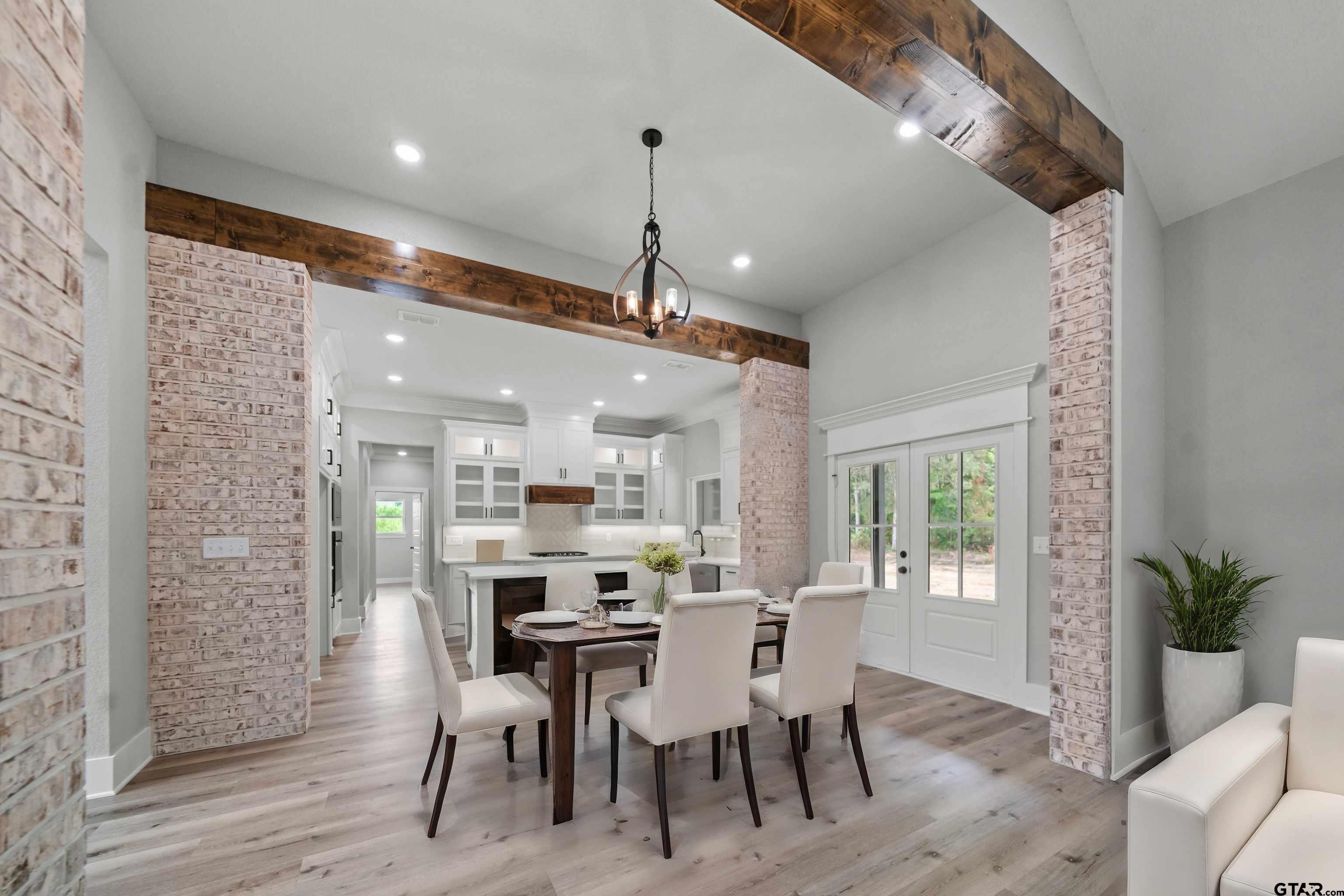 14552 Fallow Lane Tyler, TX 75706 - Photo 10 of 38 a dining room with stainless steel appliances kitchen island granite countertop a dining table chairs and a potted plant