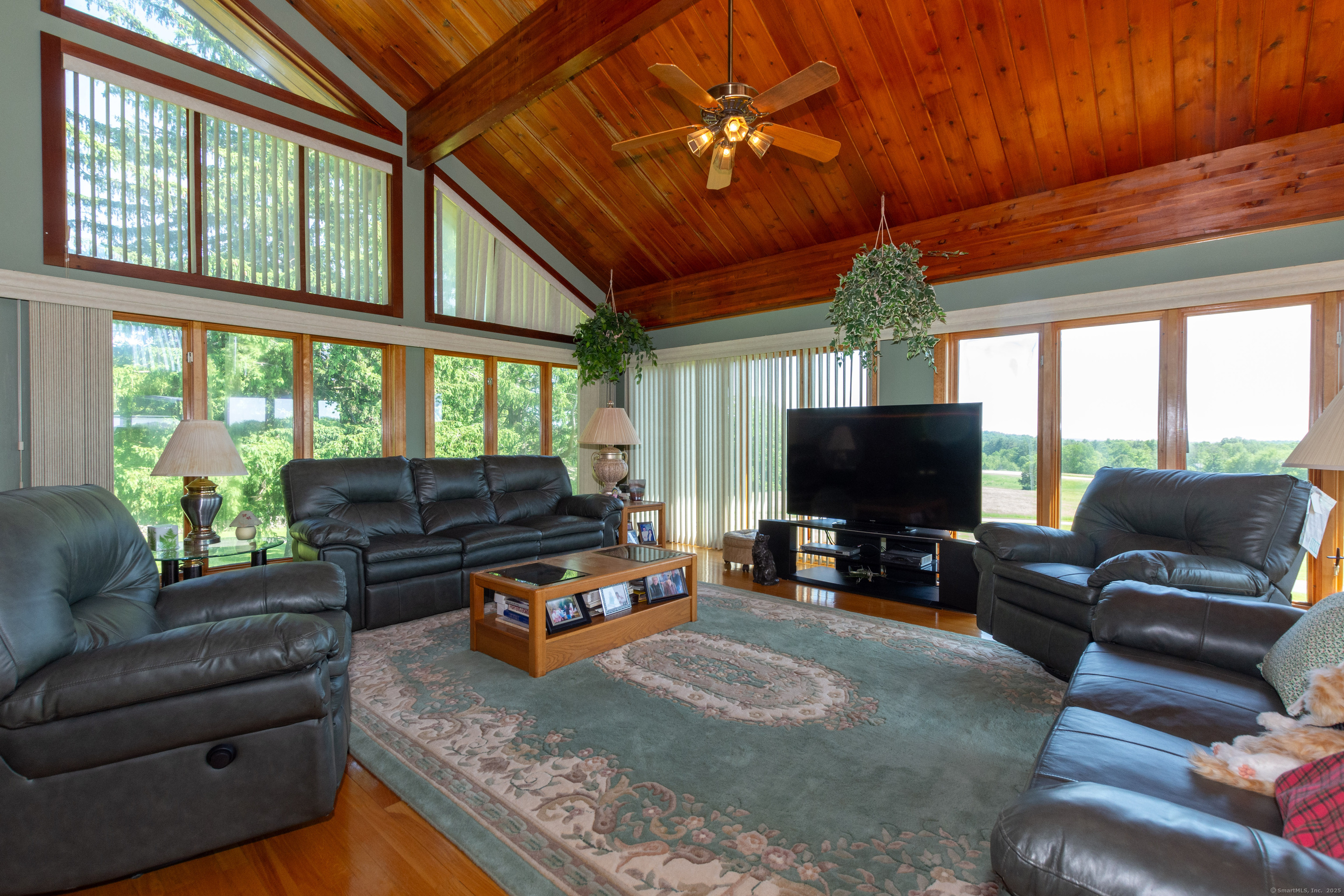 80 Bungay Hill Road Woodstock, CT 06282 - Photo 15 of 39 a living room with furniture a flat screen tv and a floor to ceiling window