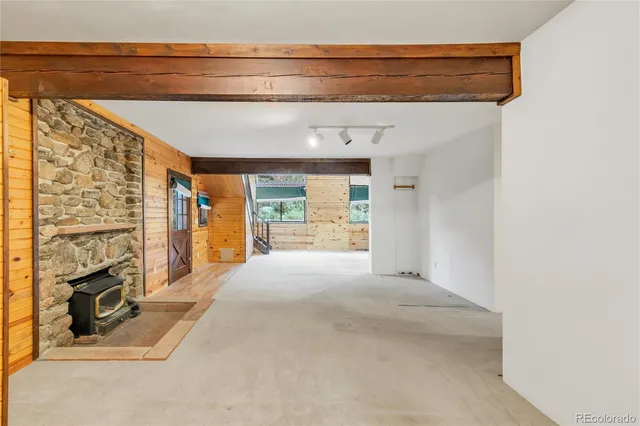 a view of a livingroom with wooden floor and a fireplace