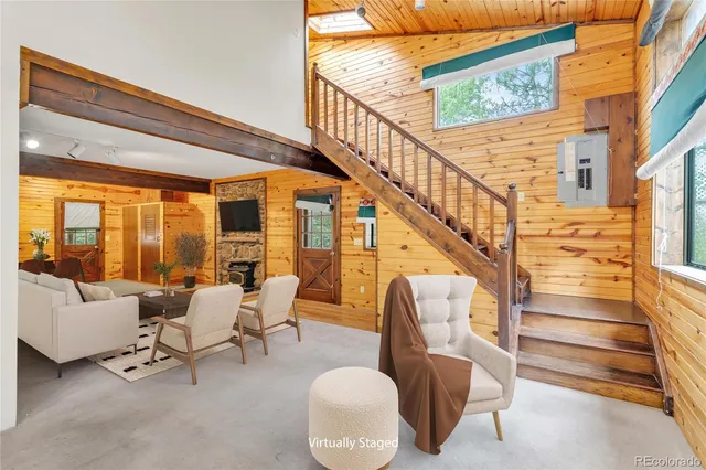 a living room with furniture and stairs
