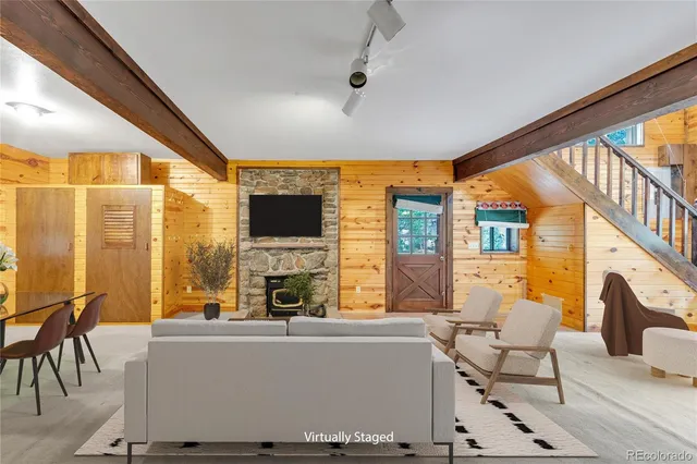 a living room with fireplace furniture and a flat screen tv
