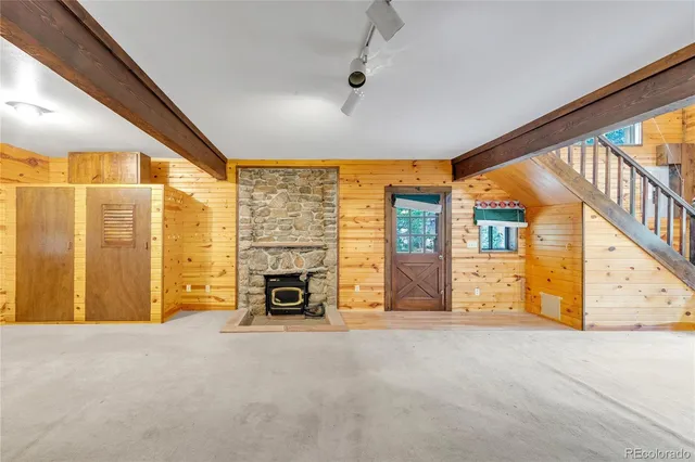 an empty room with furniture and fireplace