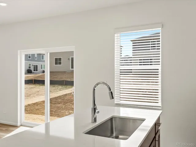 a kitchen with a sink and a large window