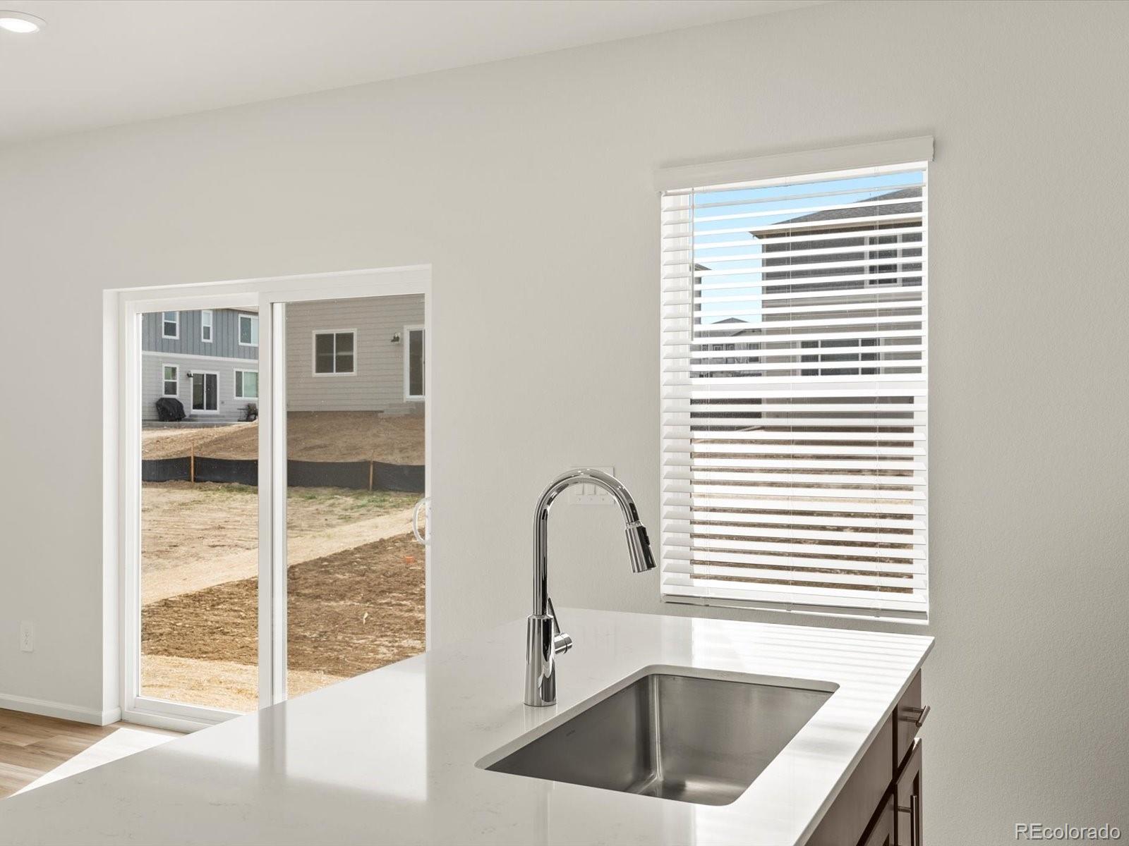 7304 West 27th St Road Greeley, CO 80634 - Photo 12 of 30 a kitchen with a sink and a large window