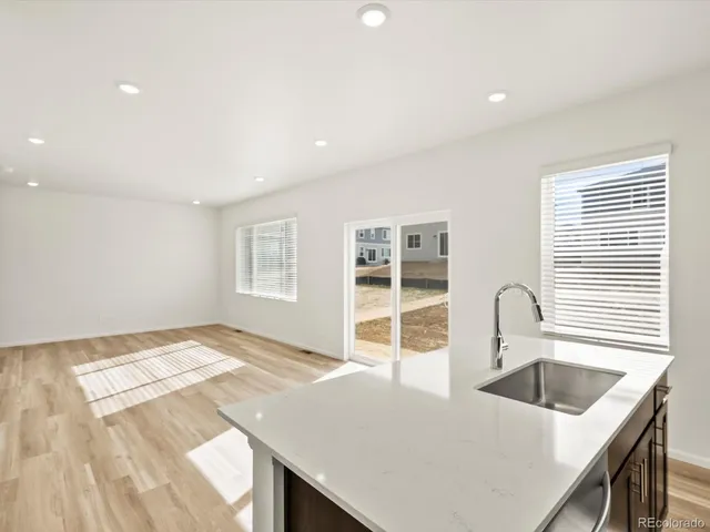 a kitchen with a sink a stove and a refrigerator