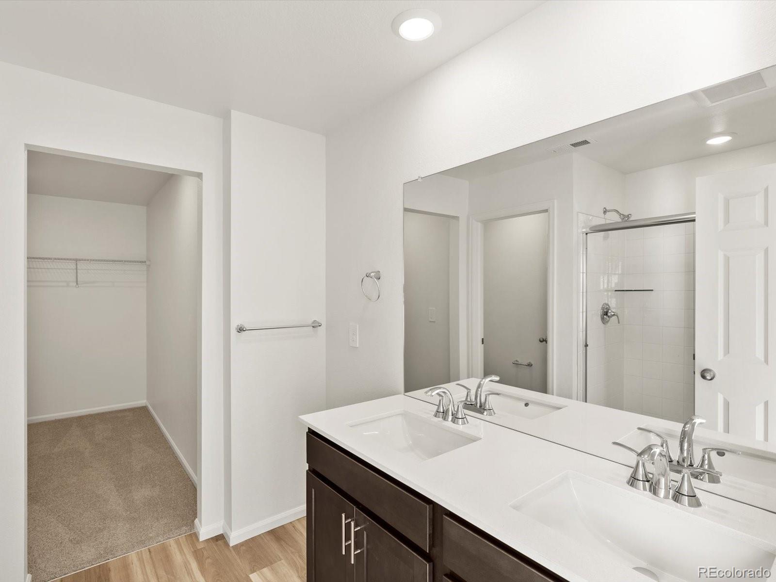 7304 West 27th St Road Greeley, CO 80634 - Photo 24 of 30 a bathroom with a sink and a mirror
