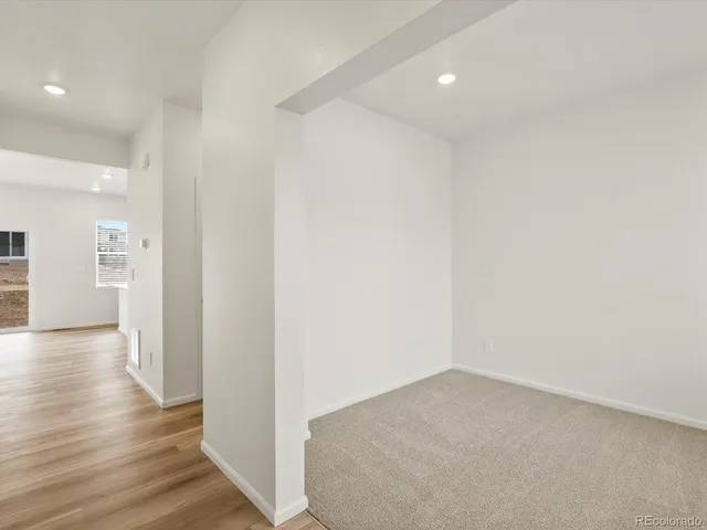a view of hallway with wooden floor