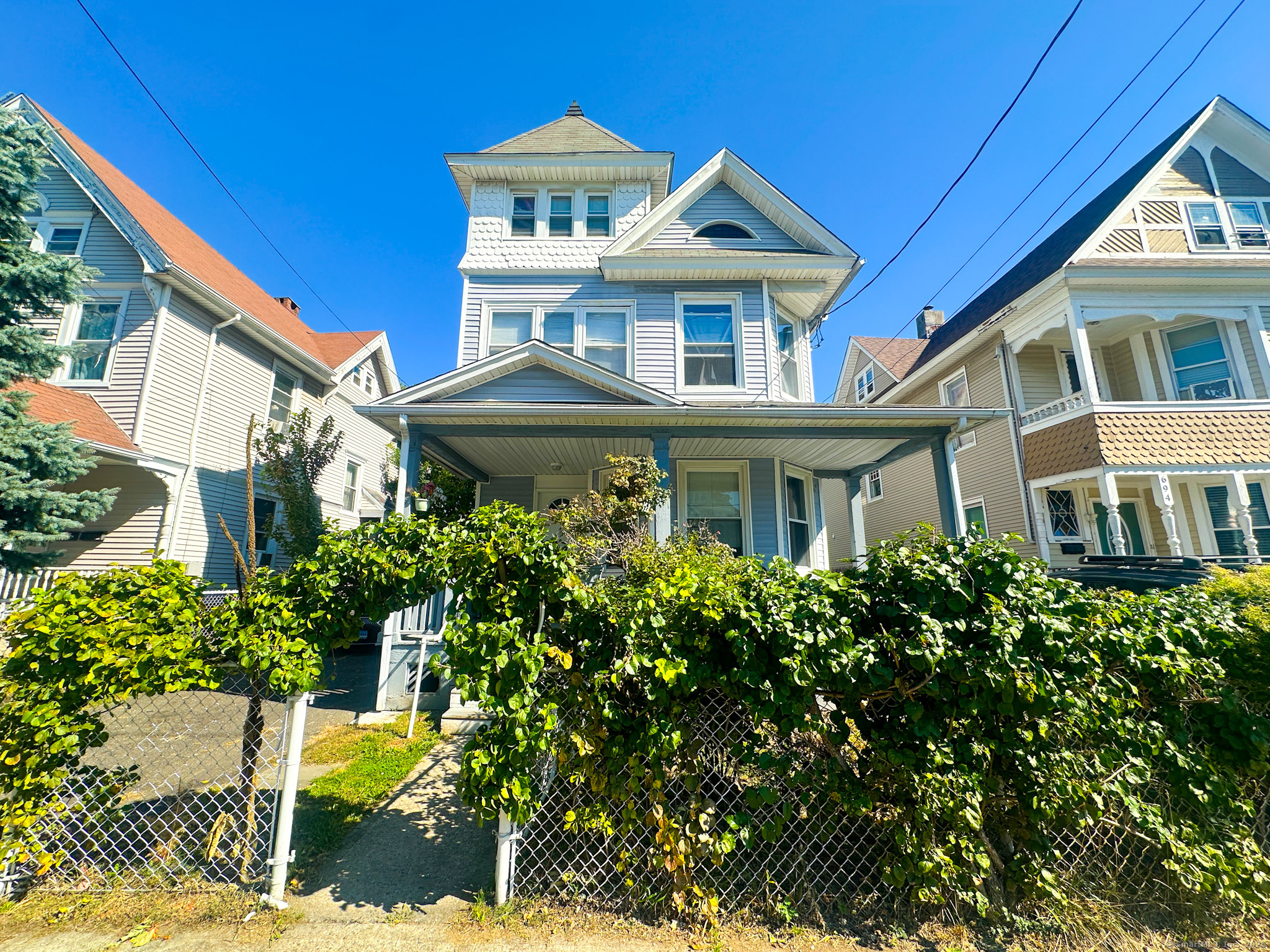 a front view of a residential houses with yard