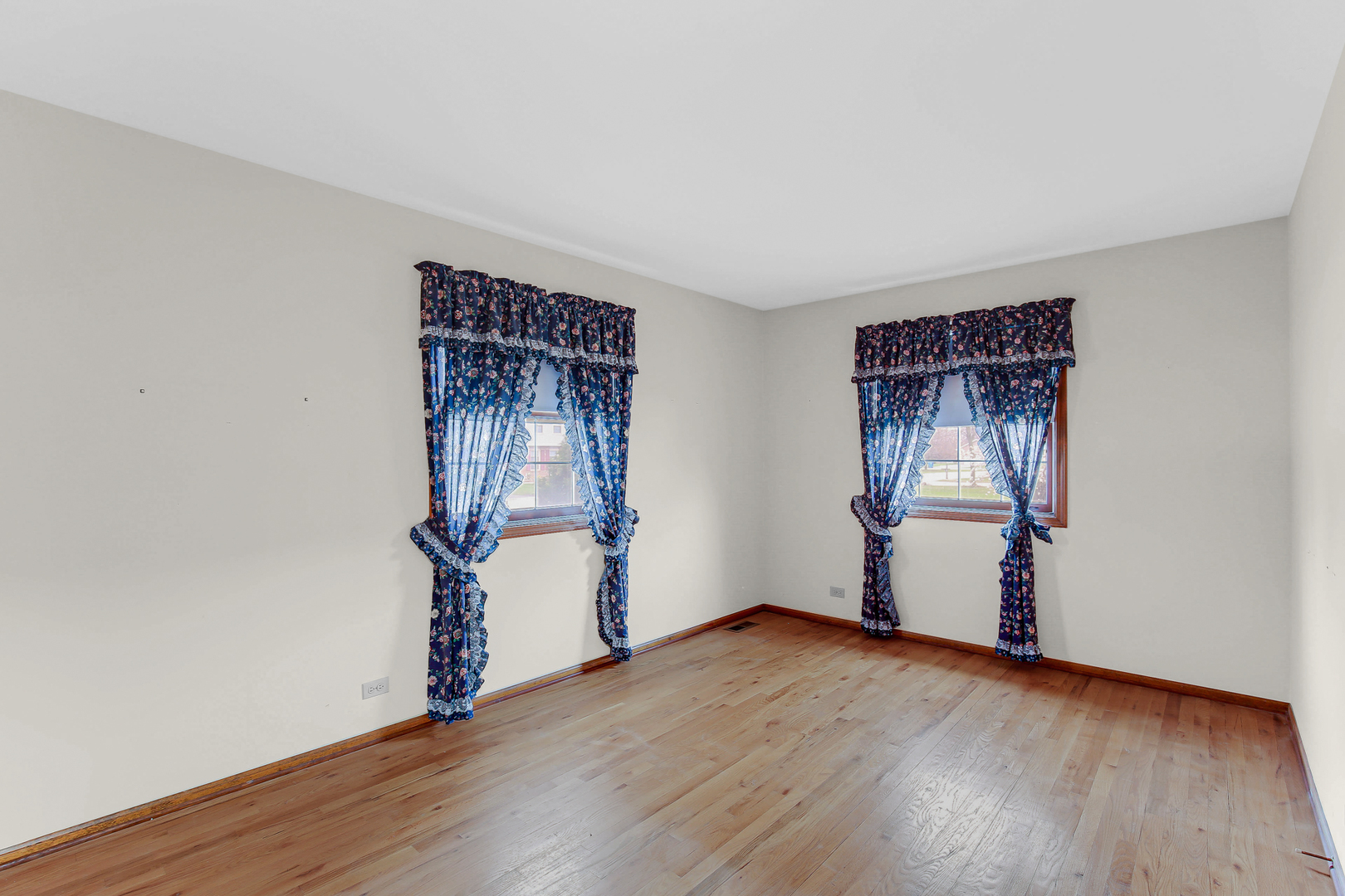 3723 Ronald Road Crete, IL 60417 - Photo 19 of 25 an empty room with wooden floor and windows