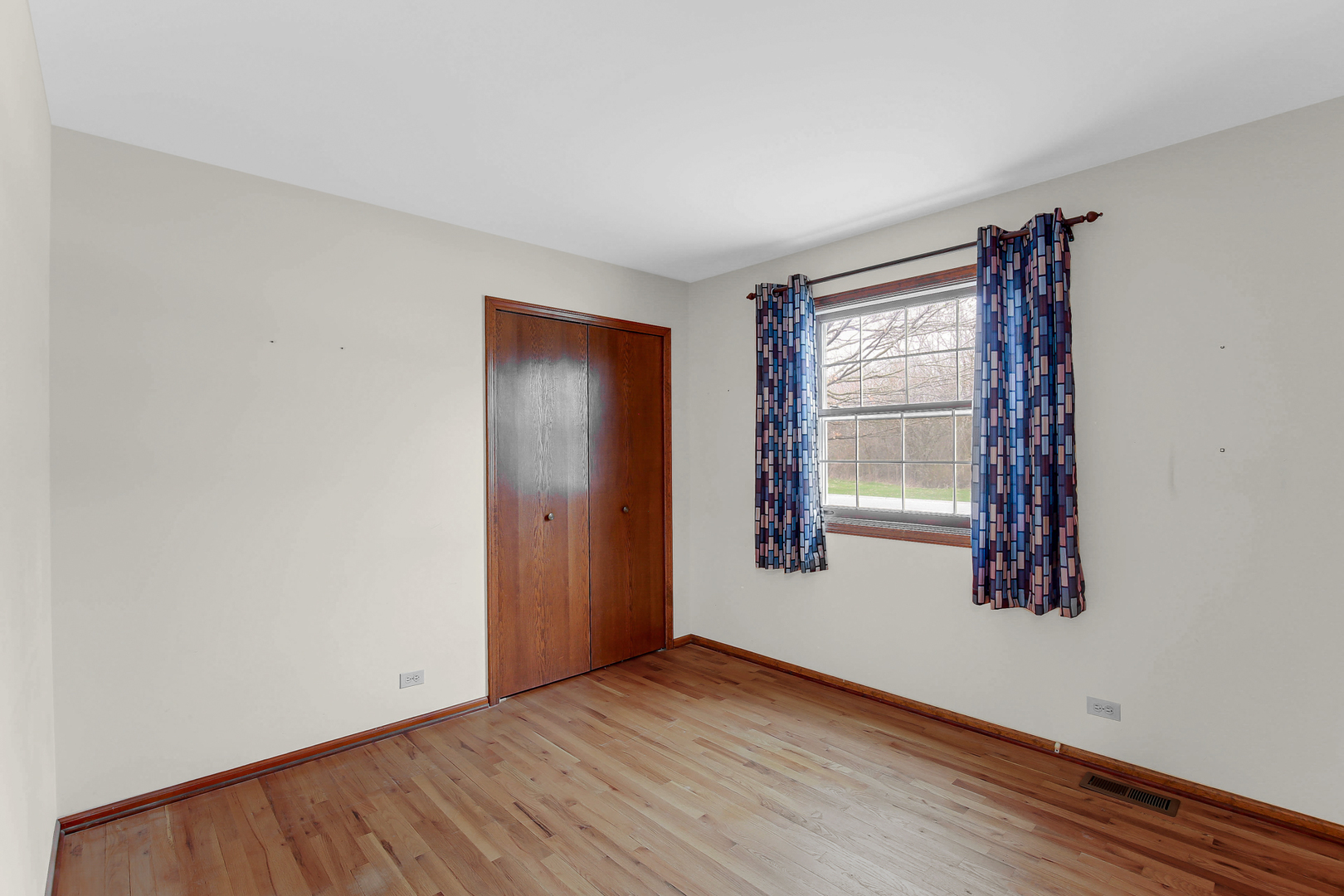 3723 Ronald Road Crete, IL 60417 - Photo 21 of 25 an empty room with wooden floor and windows
