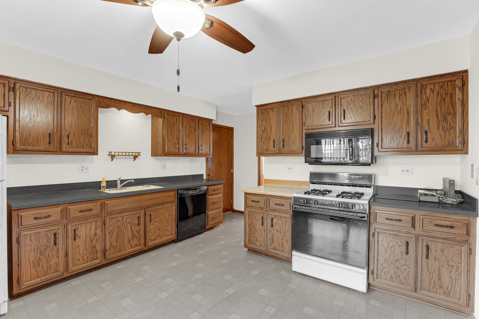 3723 Ronald Road Crete, IL 60417 - Photo 9 of 25 a kitchen with white cabinets stainless steel appliances and sink