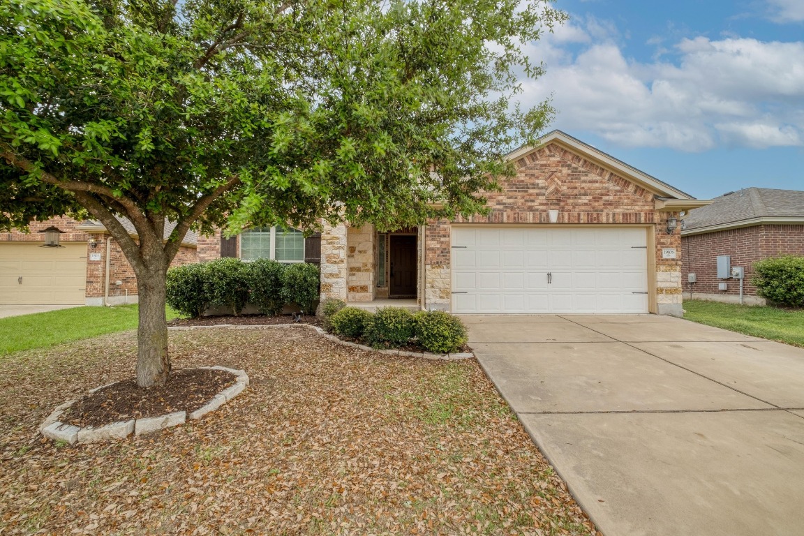 19108 Sparrow Trail Pflugerville, TX 78660 - Photo 1 of 1 a front view of a house with a yard and garage