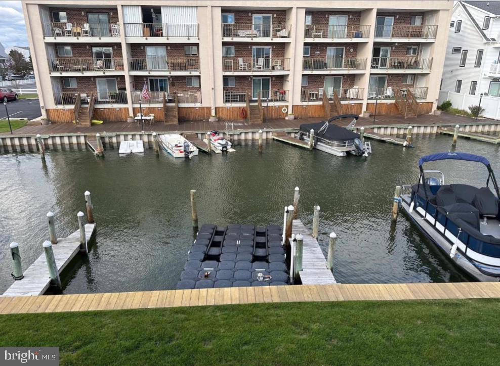8908 Rusty Anchor Road, Unit 20501 Ocean City, MD 21842 - Photo 3 of 15 a view of a lake with a building and outdoor space
