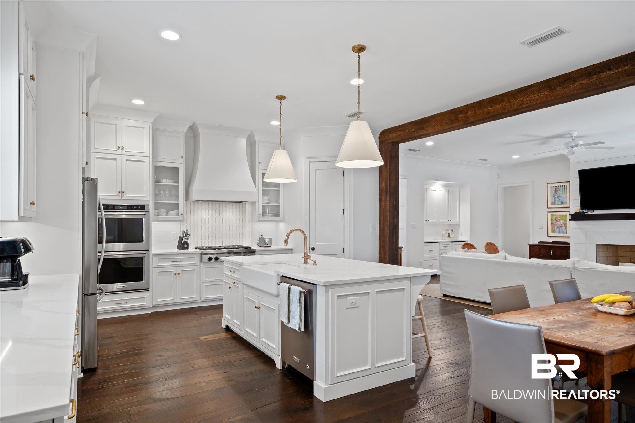 3713 Old Shell Road Mobile, AL 36608 - Photo 11 of 52 Kitchen with white cabinetry, sink, an island with sink, custom range hood, and appliances with stainless steel finishes