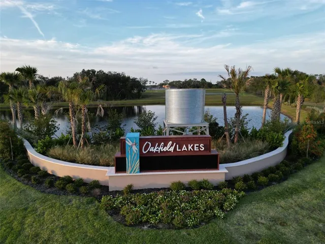 a view of a park with sign board and lake view