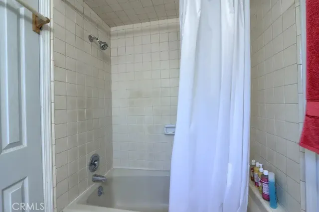 a bathroom with a shower and a bath tub